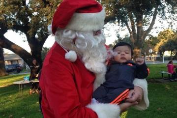 Santa in Central Park holding a child