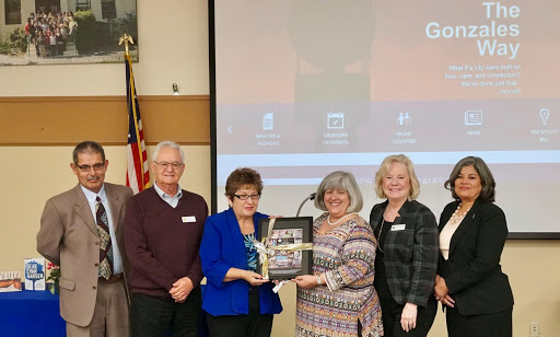 Gonzales Leadership accepting award for child development