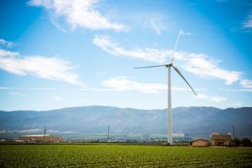 Taylor Farms Wind Turbine towering above field in Gonzales CA