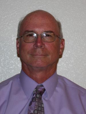 Headshot of Harold Wolgamott agains white wall
